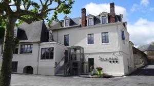 a white house with a tree in front of it at Parc Hôtel Pompadour in Arnac-Pompadour