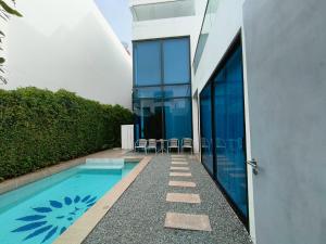 a house with a swimming pool next to a building at TYb04 芭提雅北歐風格四臥室別墅 in Pattaya South