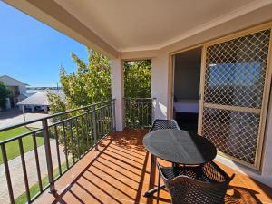 a balcony with two chairs and a table on it at Pelican Shore Villa 11- Kalbarri WA in Kalbarri +5 photos