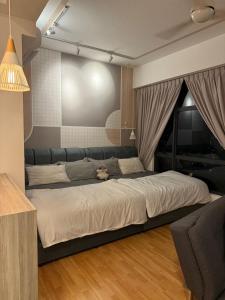 a bedroom with a large bed with a teddy bear on it at Imperium Resident Kuantan Eleven-7 in Kuantan