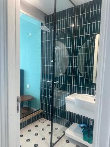 a bathroom with a glass shower and a sink at Vy hillside the apartment sunset town city in Phu Quoc