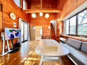 a living room with a couch and a table at 花の街589# Nature Escape BBQ in Tsumagoi