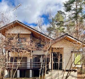 an old house with trees in front of it at 花の街589# Nature Escape BBQ in Tsumagoi