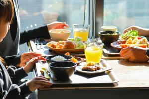 a group of people sitting at a table with food at Sanco Inn Grande Nagoya -HOTEL & SPA- in Nagoya +45 photos