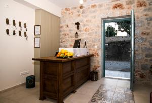 a kitchen with a counter with a bowl of fruit on it at The Olive Yard in Gythio