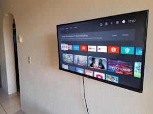 a flat screen tv hanging on a wall at Etinoff's Apartments in Sutherlands Development