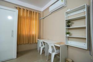 a room with a table and chairs and a window at Akshay BnB & HomeStay in Lucknow