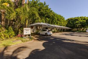 a car parked under an umbrella on a street at West Island by Horizon Holidays in Rivière Noire +96 photos