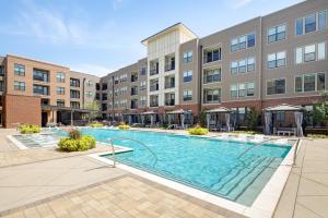 an image of a swimming pool in front of a building at AMLI Addison in Addison