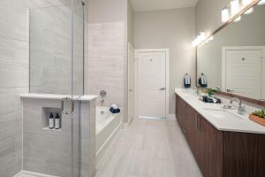 a bathroom with a shower and a sink at AMLI Addison in Addison +22 photos