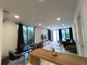 sala de estar con mesa y sillas y sala de estar. en TYb03 芭提雅北歐風格三臥室別墅, en Pattaya South