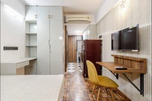 a room with a table and a television and a desk at Super Luxury Independent Studio in Gurgaon