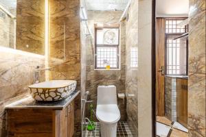 a bathroom with a sink and a toilet and a shower at Super Luxury Independent Studio in Gurgaon +33 photos