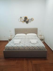 a bedroom with a large bed with two pillows at La Via del Mare in Giardini Naxos