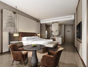 a bedroom with a bed and a table and chairs at Jianguo Hotel Global Branch in Beijing