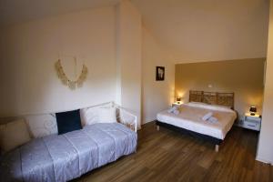 a bedroom with two beds in a room at - Ancien Chai 6 pers - Vignobles - Nature - Piscine - Les hauts de la Rameyo - in Gaillac