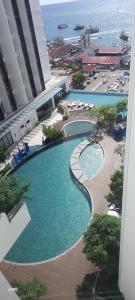 an overhead view of two swimming pools in a resort at Bian's Cozy Suite in Kota Kinabalu