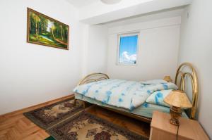 a bedroom with a bed and a window at Apartment Polaris in Ohrid