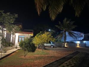 a car parked in front of a house at night at Cealora Resort in Dambulla