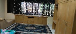 a kitchen with a rug on the floor and a window at Alfian Homestay in Johor Bahru