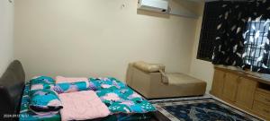 a living room with a couch and a chair at Alfian Homestay in Johor Bahru