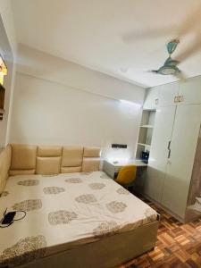 a small bedroom with a bed and a desk at Super Luxury Independent Studio in Gurgaon