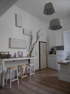 a kitchen with a table and two stools in it at 4 Camere A Trani in Trani