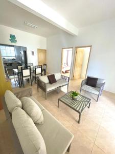 a living room with a couch and a table at The Beach House Rodrigues in Rodrigues Island