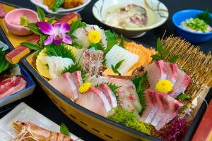a tray of food with sushi and other foods at 下田温泉 湯本の荘 夢ほたる in Amakusa