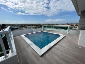 a balcony with a swimming pool on top of a building at Summer Apartment in Porto De Galinhas
