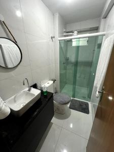 a bathroom with a shower and a toilet and a sink at Summer Apartment in Porto De Galinhas +16 photos