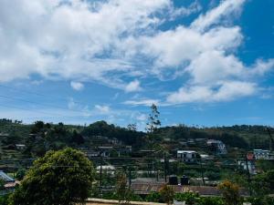 a view of a city under a cloudy sky at Ambula Resort in Nuwara Eliya