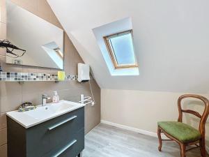 a bathroom with a sink and a mirror and a chair at La Ferme de Kerraoul in Combrit +31 photos