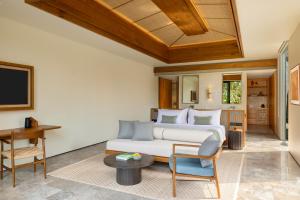 una camera da letto con un letto e una scrivania in una stanza di Alaya Suites Ubud ad Ubud