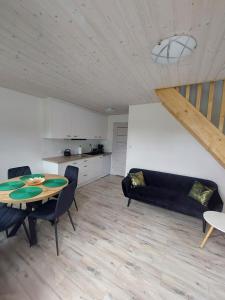 a living room with a table and a couch at Domki M&M in Kołczewo