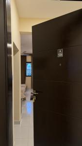 a black door in a room with a living room at Bait Al Hakem Guest Rooms in Salalah +268 photos