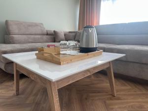 a coffee table with glasses on it in a living room at Harmony B&B in Fălticeni