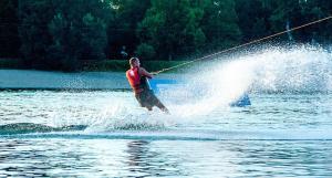 a man is water skiing on a lake at Apartment ADA RB Belgrade in Čukarica +4 photos