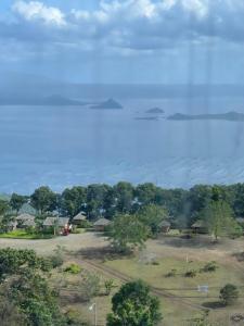 a view of a field with trees in the background at Balay Nuevo in Kaybagal +5 photos