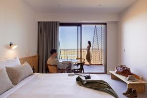a man sitting at a table in a hotel room at Monarto Safari Resort in Monarto +48 photos