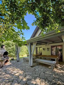 a patio with two benches and a fire place at 44 George House - Pool, Jacuzzi, Sauna, View in Tilaj