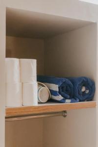a shelf with rolls of toilet paper on it at Taruchi 4 bedrooms villa in Kesiman +20 photos