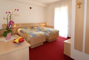 Postel nebo postele na pokoji v ubytování Hotel Zanon