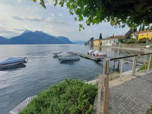 a group of boats docked at a dock on a lake at Casa Sinetta Como Lake in Acquaseria