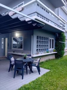 a patio with a table and chairs in front of a house at Buddies Charm House in Aveiro