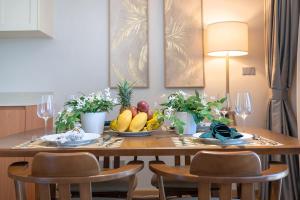 a dining room table with fruit on top of it at Laguna Beachside residences apartamens, walking distance to the sea in Bang Tao Beach