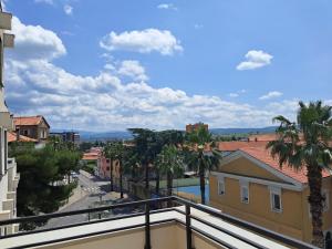 a view from a balcony of a city street with palm trees at Mediterranean Rooms Koper in Koper