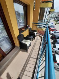 a balcony of a building with chairs and windows at Džoni in Sarajevo