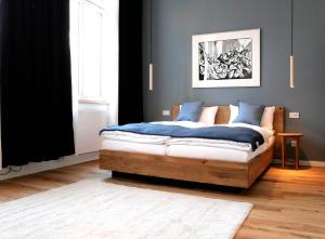 a bedroom with a bed with blue pillows at klein & fein Gästehaus in Schwelm