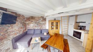 a living room with a couch and a table at Pagotin " L'Instant Nature" in Métabief